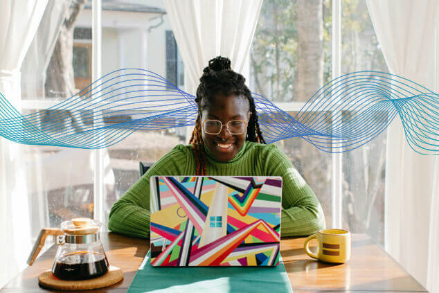 Woman at a desk on laptop with data around her