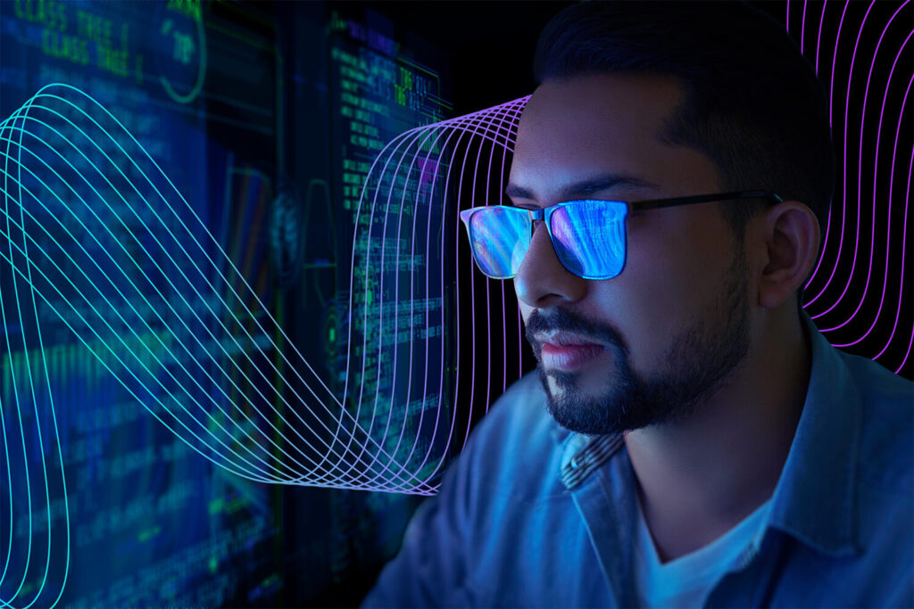 Man looking at data on a computer screen