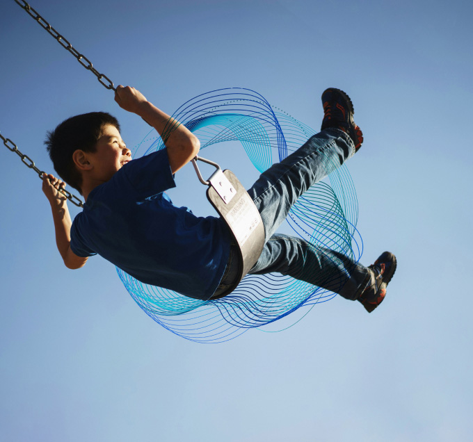 Swinging child with lines behind